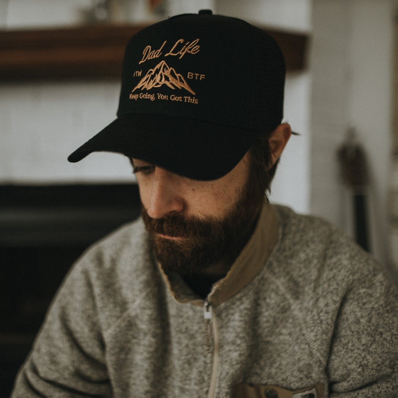 dad wearing black trucker hat with mountain and dad life text